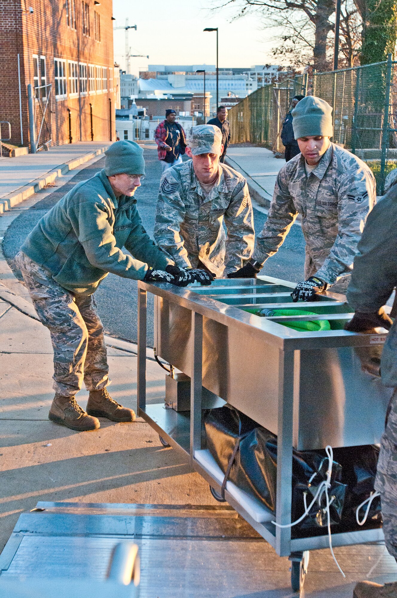 Members of the Kentucky Air National Guard’s 123rd Force Support Squadron unload kitchen equipment from a Disaster Relief Mobile Kitchen Trailer at McKinley Technology High School in Washington, D.C., on Jan. 19, 2013. They were among nine Kentucky Air Guardsmen who deployed to the nation’s capital to provide food and lodging for National Guard members supporting the inauguration of President Barack Obama. (Kentucky Air National Guard photo by Senior Airman Vicky Spesard)