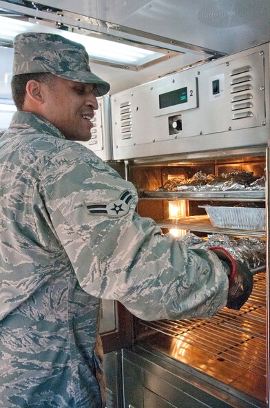 Airman 1st Class Jordan Newby of the Kentucky Air National Guard’s 123rd Force Support Squadron cooks inside a Disaster Relief Mobile Kitchen Trailer for military police and security forces personnel on Jan 19, 2013, in Washington D.C. Newby was one of nine Kentucky Air Guardsmen who deployed to the nation’s capital to provide food and lodging for National Guard members supporting the inauguration of President Barack Obama. (Kentucky Air National Guard photo by Senior Airman Vicky Spesard)