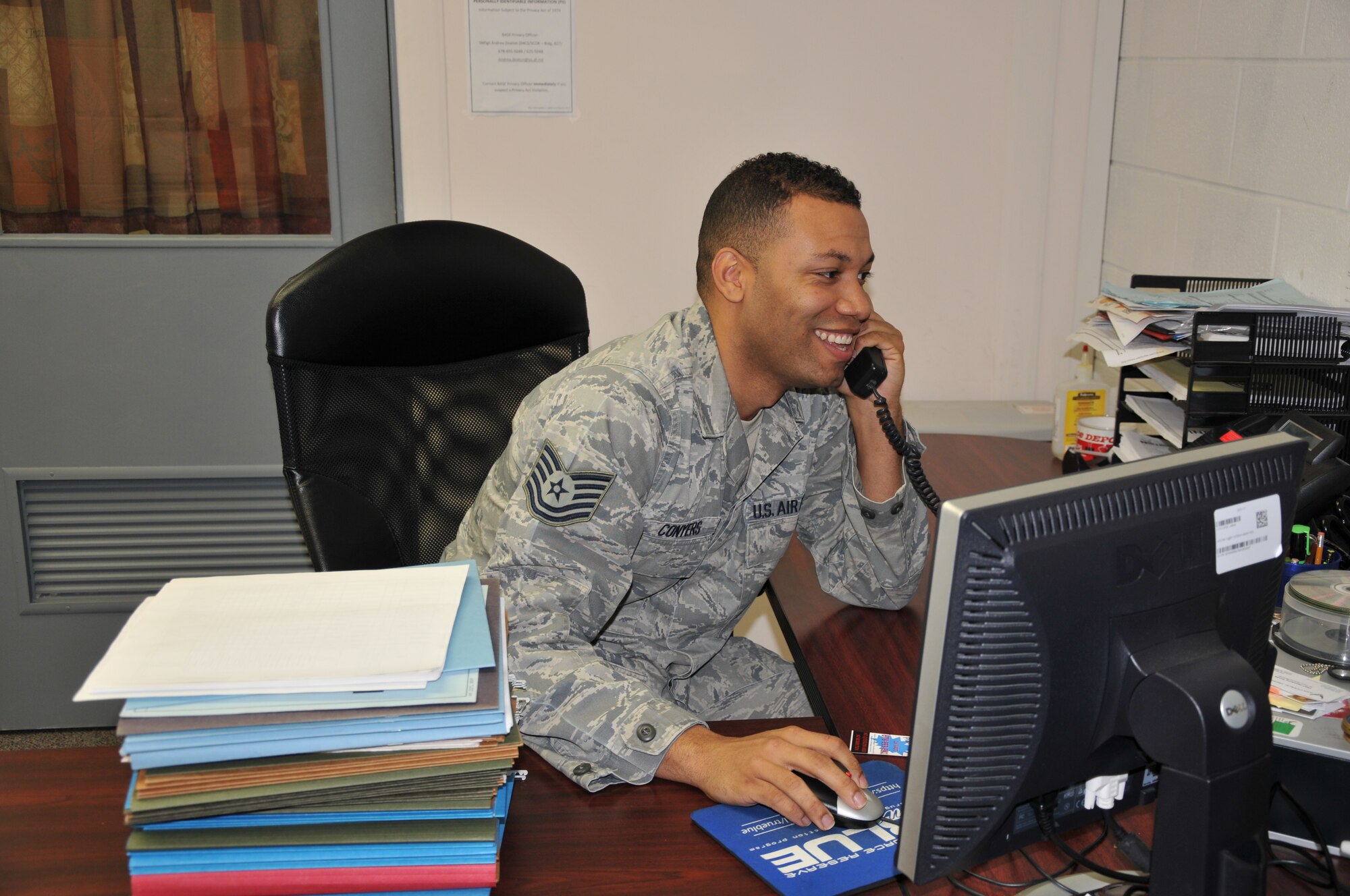Tech. Sgt. Richard Conyers, 94th Equal Employment Office interim director, answers the phone in the 94th Airllift Wing Equal Employment Office. Conyers and EEO specialists often need to multi-task to handle the multiple additional duties they have. (U.S. Air Force photo/Senior Airman Elizabeth Van Patten)