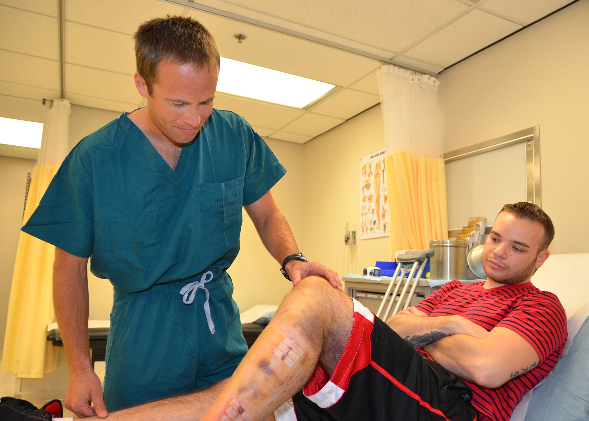 Maj. (Dr.) James Bales, 81st Surgical Operations Squadron, checks Senior Airman Joshua Hoover’s post-operative progress Jan. 14, 2013, at the Keesler Hospital, Keesler Air Force Base, Miss. Bales is a returning coach for the 2013 Warrior Games May 11-17 in Colorado Springs, Colo. Hoover is an 81st Training Group command post member.  (U.S. Air Force photo by Steve Pivnick)