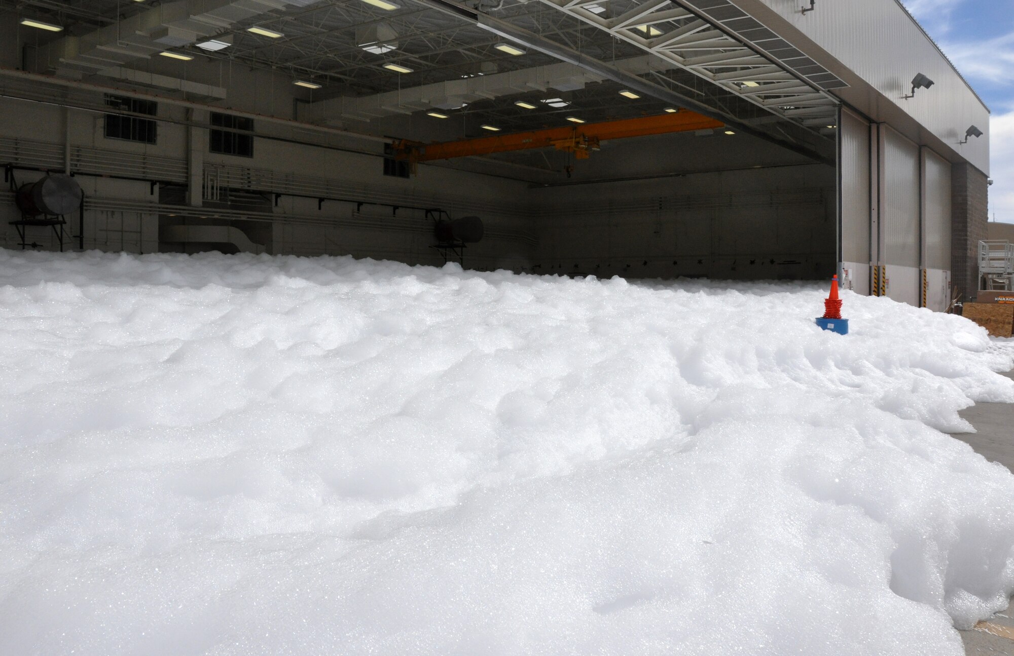 High Expansion Foam runs on the flight line outside of the 943rd Maintenance Squadron hangar at Davis Monthan Air Force Base, Ariz. A test of the 943rd MXS hangar fire suppression system was conducted on January, 23. The test ensured the fire suppression system was working properly prior to the 943rd MXS Airmen moving back into the hanger after it underwent major renovations for the past year.  (U.S. Air Force Photo/ Master Sgt. Luke Johnson)