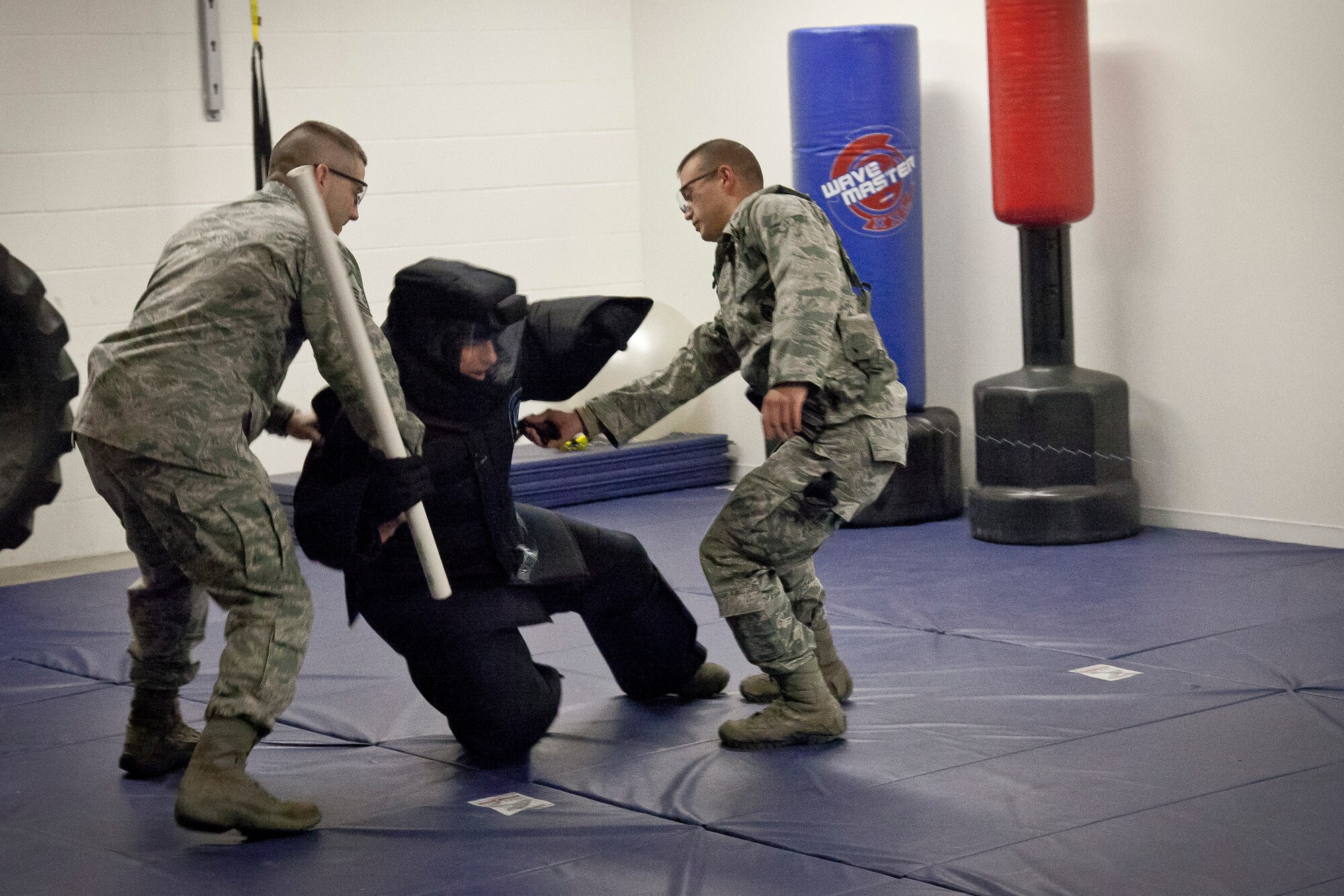 Master Sergeant Michael J. Ross, 934th Security Forces Squadron, assists Senior Airman Joshua A. Cunningham with a "suspect" takedown during a Taser training course January 22.  The new equipment is set to be implemented in the coming month at the Minneapolis-St. Paul Air Reserve Station, Minn.  (U.S. Air Force Photo/Shannon McKay)