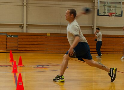 Airman 1st Class Jaime Jones, 437th Maintenance Squadron aerospace ground equipment apprentice, takes aim at an opponent during the Dorm Challenge dodgeball game Jan. 18, 2013, at Joint Base Charleston - Air Base, S.C. The quarterly Dorm Competition is a Wing initiative that is intended to encourage and incorporate all aspects of Comprehensive Airman Fitness, while also encouraging resident interaction and camaraderie. The Dorm Challenge consisted of push-ups, sit-ups and a game of dodgeball.  (U.S. Air Force photo/Airman 1st Class Ashlee Galloway) 