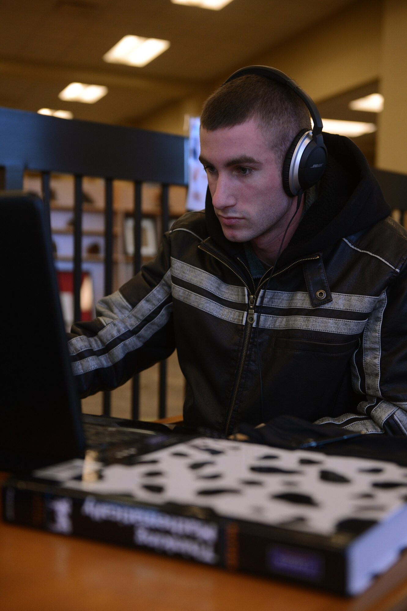 Airman 1st Class Gabe Blomfield, 20th Equipment Maintenance Squadron aircraft maintainer, works on his math homework at McElveen Library at Shaw Air Force Base, S.C., Jan. 22, 2013. The McElveen Library is scheduled to change to the McElveen Resource Center as new services are added including outdoor adventure trip reservations, computerized gaming room, and special events planning and coordination.. Despite the additional services at McElveen, it will still offer internet research and Wi-Fi, traditional education resources, a multimedia center, group work stations, e-books and DVDs. (U.S. Air Force photo by Airman 1st Class Krystal M. Jeffers/Released)