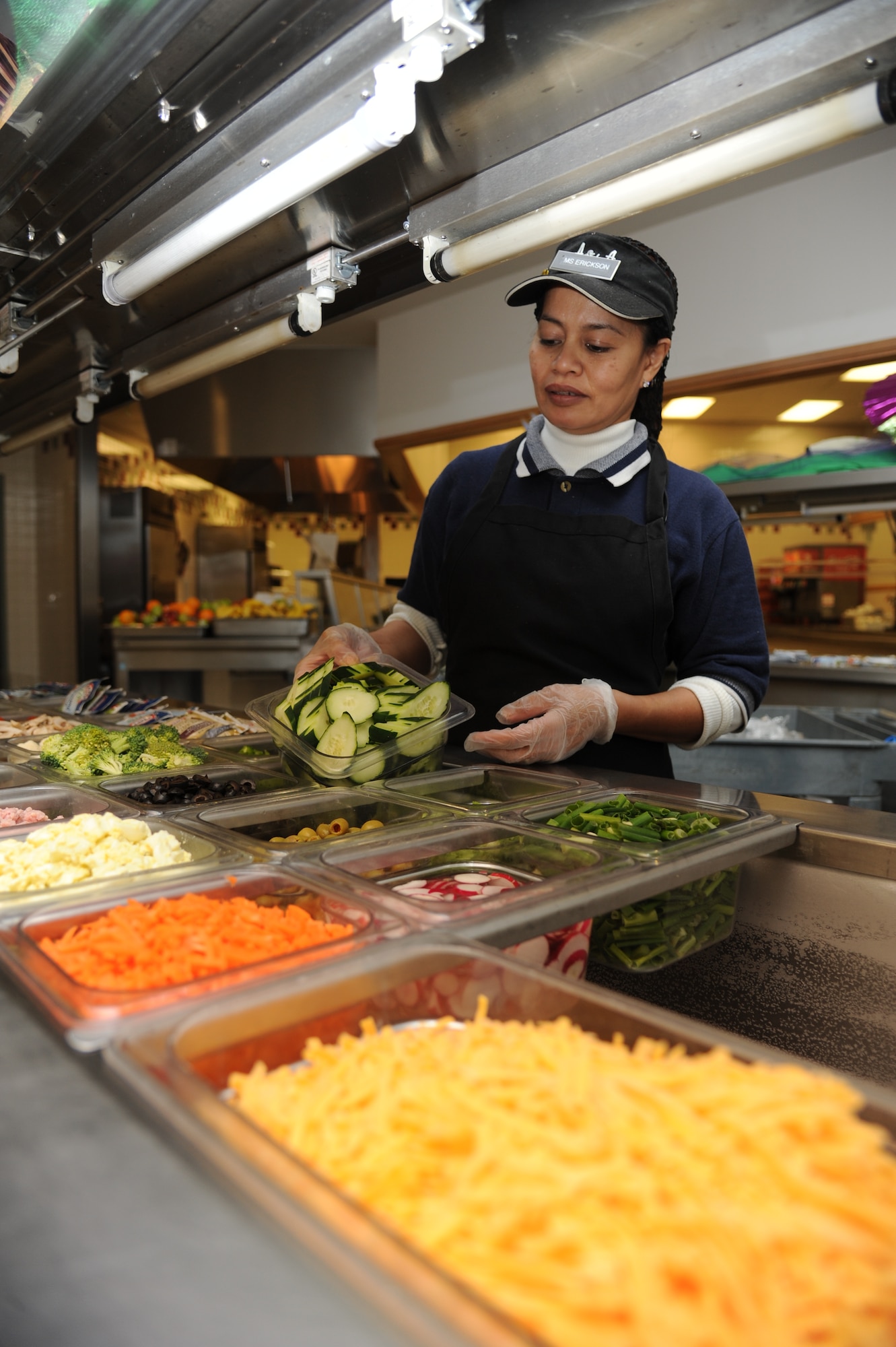 Julie Erickson, salad maker, prepares the salad bars at the Azalea Dining Facility Jan. 22, 2013, at Keesler Air Force Base, Miss.  The 81st Force Support Squadron food service operations accommodated a $1.25 million budget cut by shortening hours at the Live Oak Dining facility and expanding hours at Azalia and Magnolia dining halls.  (U.S. Air Force photo by Kemberly Groue)