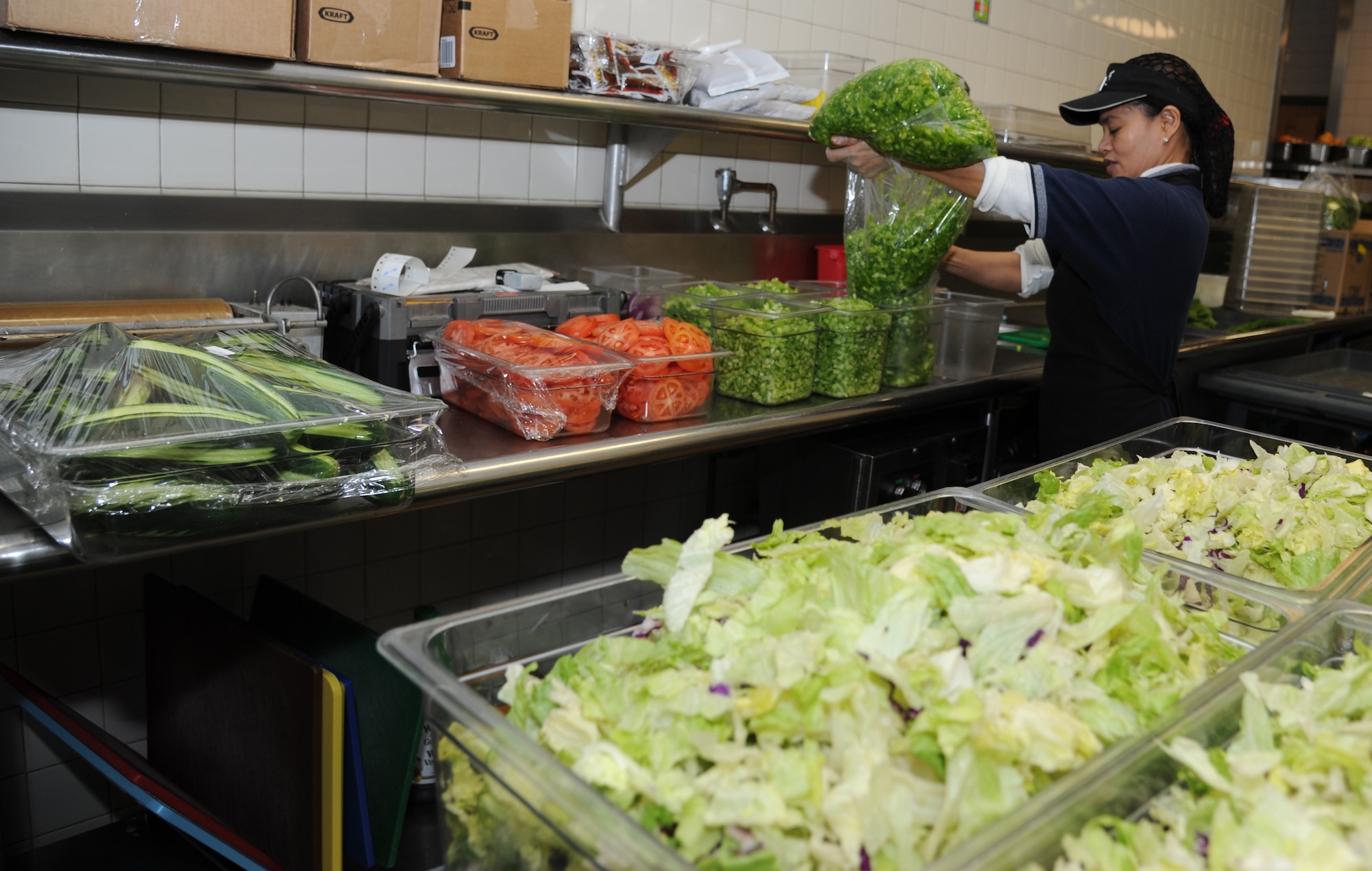 Julie Erickson, salad maker, prepares the salad bars at the Azalea Dining Facility Jan. 22, 2013, at Keesler Air Force Base, Miss.  The 81st Force Support Squadron food service operations accommodated a $1.25 million budget cut by shortening hours at the Live Oak Dining facility and expanding hours at Azalia and Magnolia dining halls.  (U.S. Air Force photo by Kemberly Groue)