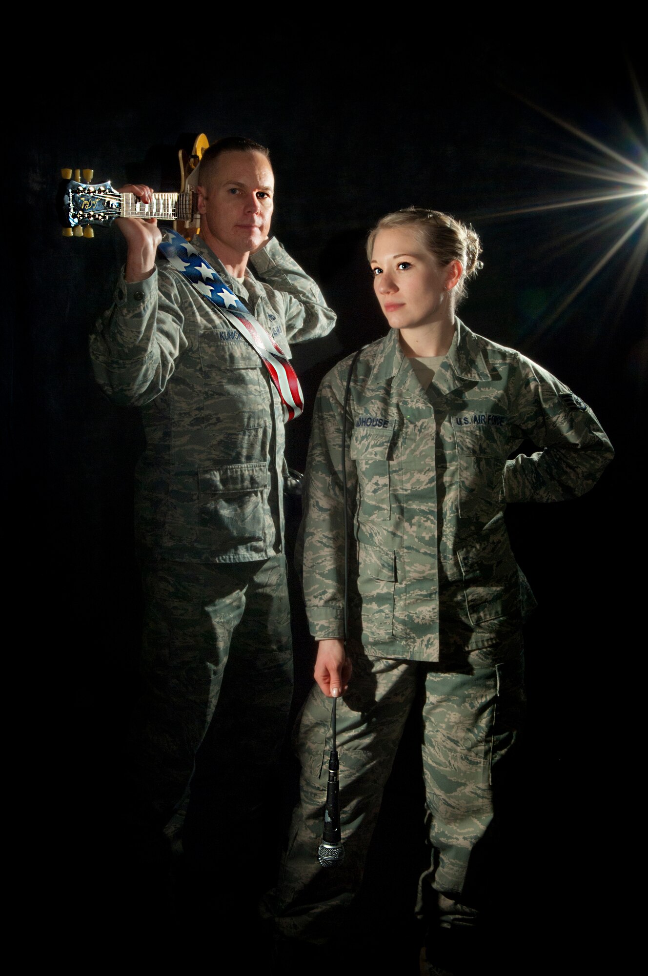 MINOT AIR FORCE BASE, N.D. -- Lt. Col. David Kunick, 5th Munitions Squadron commander and Staff Sgt. Heather Veldhouse, 5th Munitions Squadron pose for a photo here, Jan. 22. Kunick and Veldhouse are both members of RedBall, a local band comprised of 5th Bomb Wing-assigned members. The band boosts morale while providing a great outlet for stress. (U.S. Air Force photo/Tech. Sgt. Aaron Allmon)
