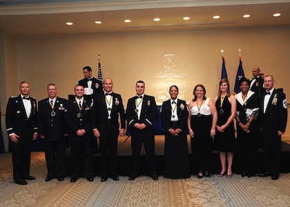 Colonel Darren Hartford, 437th Airlift Wing commander (left), and Chief Master Sgt. Larry Williams, 437th Airlift Wing command chief  (right), and the 437th AW Annual Award winners gather after the 437th AW Annual Awards Banquet at the Charleston Club, Jan. 18, 2013 at Joint Base Charleston - Air Base, S.C.  (Left to right) Master Sgt. Serge Ladd, 437th Aerial Port Squadron, Airman 1st Class Zachary Cozzens, 437th Operations Support Squadron; Senior Master Sgt. Robert Schultz, 437th APS; 2nd Lt. Jordan Passmore, 437th APS; Master Sgt. Jadirra Walls, 437th Maintenance Squadron; Victoria Thaman; Rachel Boyd, wife of Capt. Adam Boyd,15th Airlift Squadron and Faye Ellison, 15th AS. Not pictured are Senior Airman Laura Bourdlais, 15th AS and Tech. Sgt. Lindy Warner, 15th Airlift Squadron Operations Group. (U.S. Air Force photo by Staff Sgt. Rasheen Douglas)