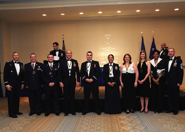 Colonel Darren Hartford, 437th Airlift Wing commander (left), and Chief Master Sgt. Larry Williams, 437th Airlift Wing command chief  (right), and the 437th AW Annual Award winners gather after the 437th AW Annual Awards Banquet at the Charleston Club, Jan. 18, 2013 at Joint Base Charleston - Air Base, S.C.  (Left to right) Master Sgt. Serge Ladd, 437th Aerial Port Squadron, Airman 1st Class Zachary Cozzens, 437th Operations Support Squadron; Senior Master Sgt. Robert Schultz, 437th APS; 2nd Lt. Jordan Passmore, 437th APS; Master Sgt. Jadirra Walls, 437th Maintenance Squadron; Victoria Thaman; Rachel Boyd, wife of Capt. Adam Boyd,15th Airlift Squadron and Faye Ellison, 15th AS. Not pictured are Senior Airman Laura Bourdlais, 15th AS and Tech. Sgt. Lindy Warner, 15th Airlift Squadron Operations Group. (U.S. Air Force photo by Staff Sgt. Rasheen Douglas)