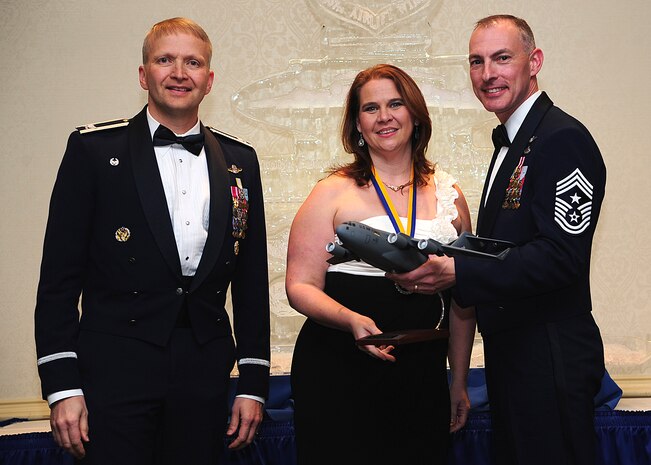 Colonel Darren Hartford, 437th Airlift Wing commander, and Chief Master Sgt. Larry Williams, 437th Airlift Wing command chief, present the 437th AW Key Spouse of the Year award to Victoria Thaman during the 437th AW Annual Awards Banquet held at the Charleston Club, Jan. 18, 2013, at Joint Base Charleston - Air Base, S.C. (U.S. Air Force photo/Staff Sgt. Rasheen Douglas)Squadron Operations Group. (U.S. Air Force photo by Staff Sgt. Rasheen Douglas)