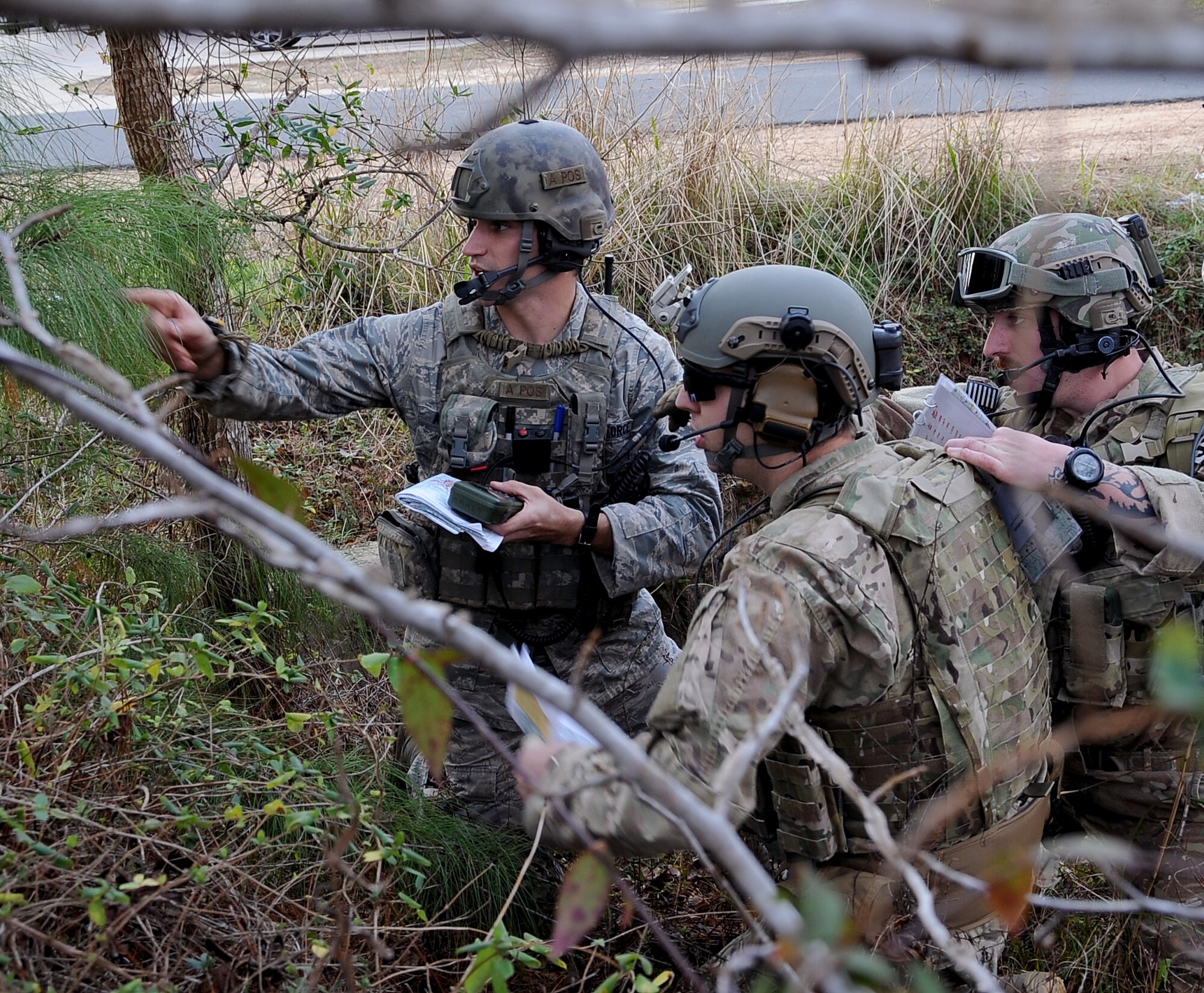 Airman 1st Class Michael Agemy, 19th Air Support Operations Squadron, Ft. Campbell, Ky., points out a simulated adversary to two other Joint Terminal Air Controllers during Green Flag East 13-03 in Leesville, La., Jan. 21. The three JTAC, along with three others, participated in the exercise as a Tactical Air Control Party assisting F-16 Fighting Falcons from Shaw Air Force Base, S.C.  The F-16 pilots provided close air support and the ability to take out any systems or adversaries trying to prevent the movement of the TACP. (U.S. Air Force photo/Staff Sgt. Amber Ashcraft)