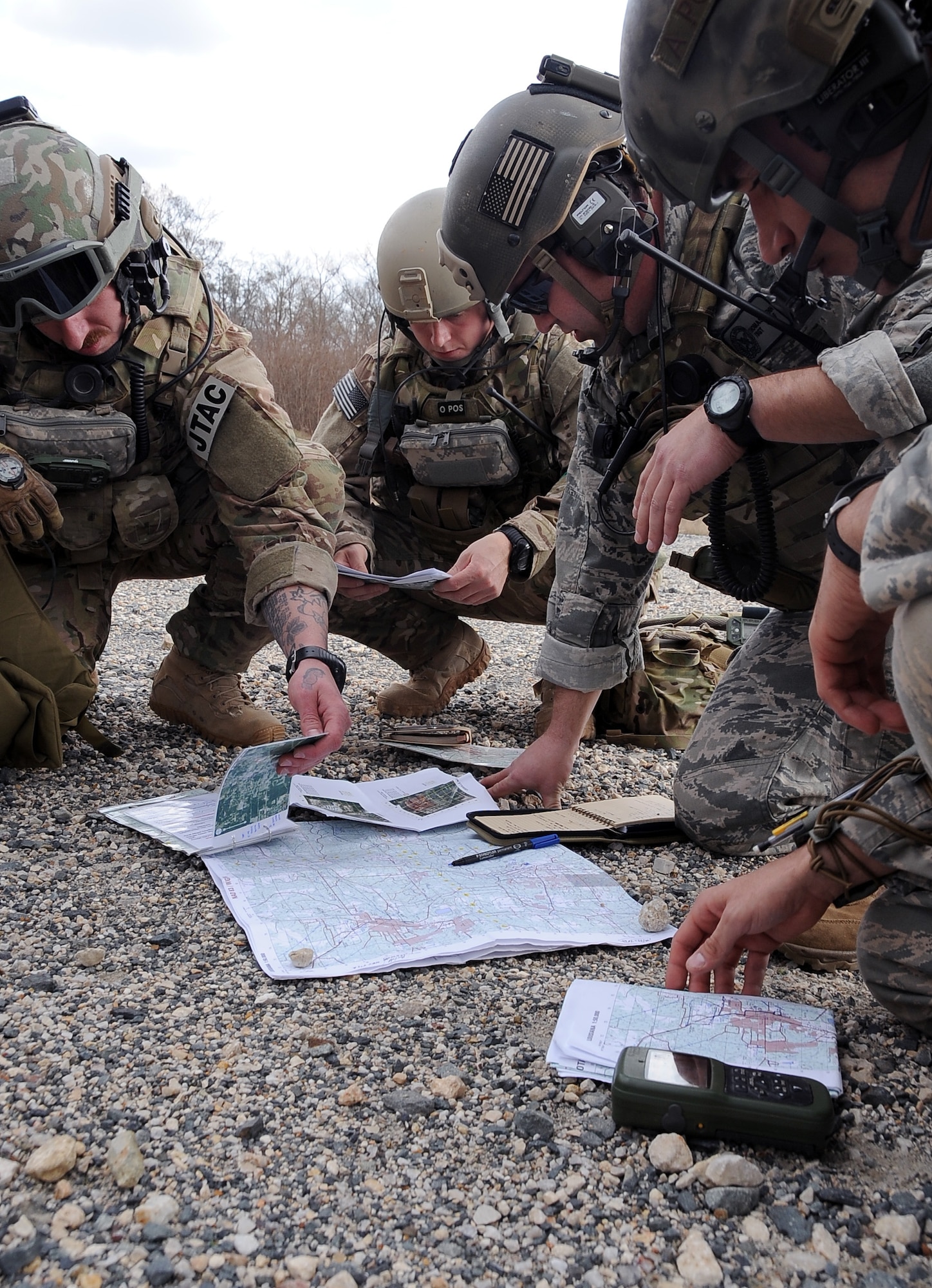 Joint Terminal Air Controllers review maps and discuss methods of movement during Green Flag East 13-03 in Leesville, La., Jan. 21. The JTACs made up a Tactical Air Control Party and interacted with F-16 Fighting Falcon pilots, from Shaw Air Force Base, S.C., who provided close air support and the ability to take out any systems or adversaries trying to prevent the movement of the TACP. (U.S. Air Force photo/Staff Sgt. Amber Ashcraft)