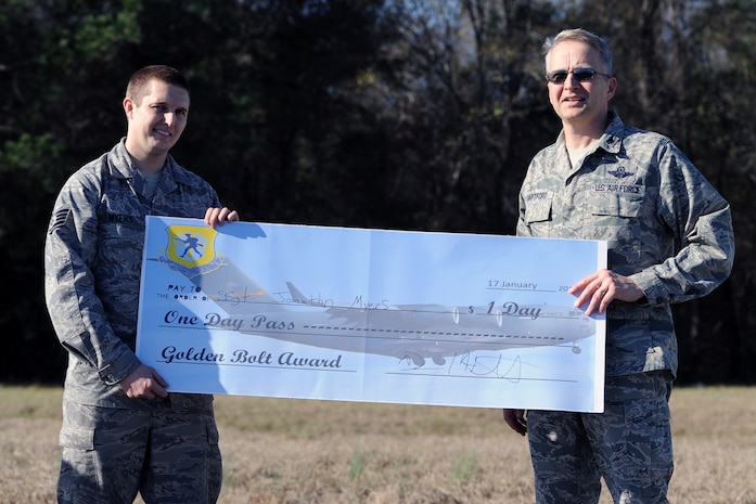 Col. Darren Hartford, 437th Airlift Wing commander, presents the "Golden Bolt Award” to Staff Sgt. Jonathan Myers, 437th Aircraft Maintenance Squadron, after the Foreign Object Debris walk Jan. 17, 2013, at Joint Base Charleston - Air Base, S.C. By removing FOD from runways and flightlines, Airmen help save the Air Force millions of dollars in costly engine repairs and replacement every year. (Courtesy photo)