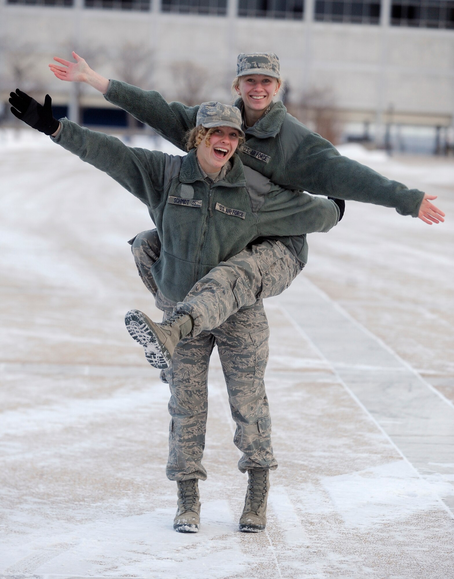 Cadets 3rd Class Kerri Schmidt (left) and Kiersten Schmidt (right) pose for a photo in the Air Force Academy Terrazzo Jan. 15, 2013. The twin sisters said by being in different cadet squadrons and having different classes, they’ve been able to develop their own interests and identities. (U.S. Air Force photo/Carol Lawrence)