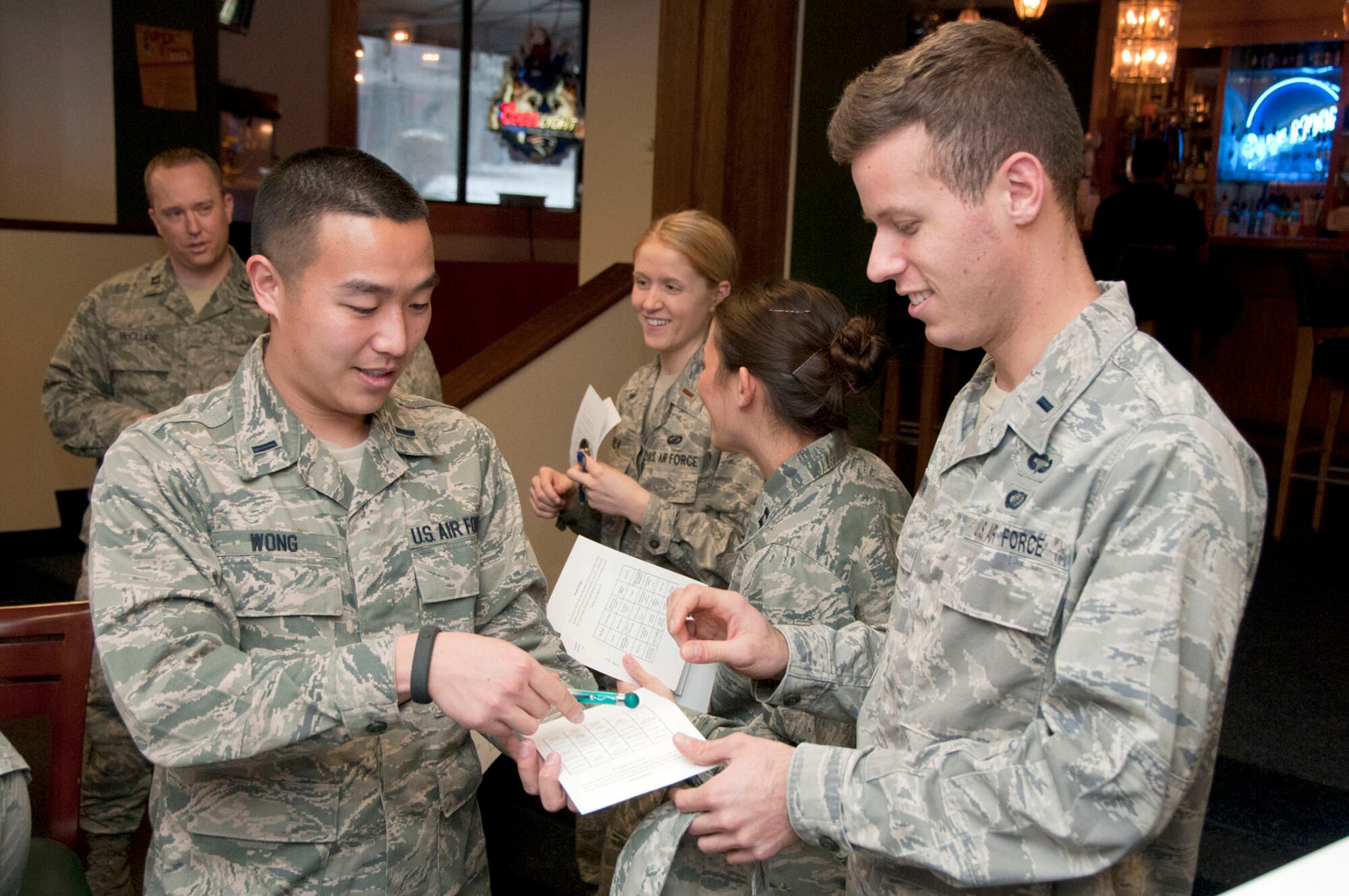 HANSCOM AIR FORCE BASE, Mass. -- 1st Lt. Adam Wong (left) and 1st Lt. Dylan Smith complete a survey as a way for new members of the Company Grade Officer Council to get to know one another at the Minuteman Commons during their first meeting of the year on Jan. 17. The CGOC is comprised of lieutenants and captains and encourages four pillars of community service, esprit de corps, professional development and base support. (U.S. Air Force photo by Mark Wyatt)
