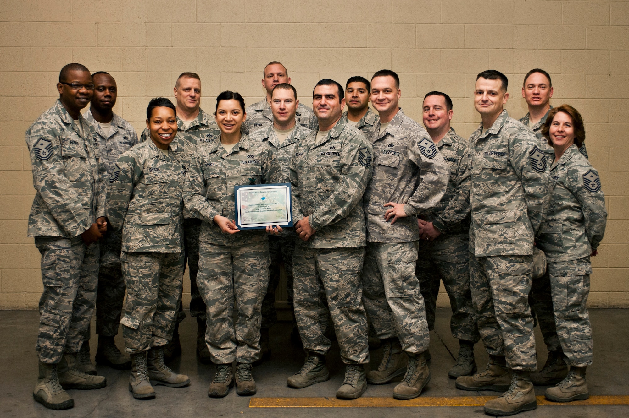 Members of the Nellis First Sergeants’ Association present the Diamond Sharp award to Staff Sgt. Vanessa Wyatt, 99th Civil Engineer Squadron fire protection technician, Jan. 23, 2013, at Nellis Air Force Base, Nev. Wyatt led the response to 54 calls, covering the full spectrum of emergencies. Her direction was paramount on command and control of a patient thrown 100ft from his motorcycle. She initiated the emergency response and provided lifesaving treatment to stop profuse bleeding. Additionally, Wyatt acted as community advocate to the Las Vegas Women's Council of Realtors by expertly conducting fire safety briefings. Wyatt was hand selected to guide the wing commander through live fire burns, showcasing Nellis/Creech Fire Emergency Services. Furthermore, she led the female "Firefighter's Combat Challenge" team, finishing 1st in the Las Vegas regional event. (U.S. Air Force Photo by Airman 1st Class Jason Couillard)