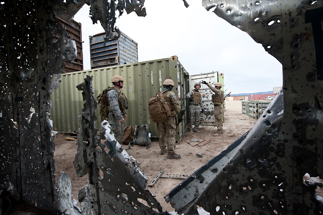 FORT CARSON, Colo. -- EOD technicians from the 21st Civil Engineer Squadron search for unexploded ordnance on a mock forward operating base during a training exercise Jan. 10 at Fort Carson. Exercises like this are designed to expose Airmen to the physical and mental fatigue experienced while deployed. The Airmen from the 21st EOD flight use the training learned in these exercises to fulfill their role as a defensive force at home and while deployed. (U.S. Air Force photo/Staff Sgt. J. Aaron Breeden)