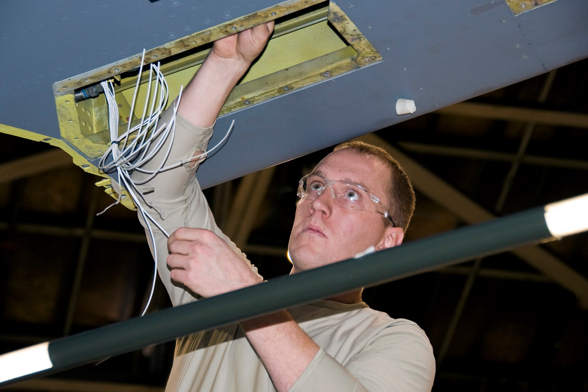 GRISSOM AIR RESERVE BASE, Ind. -- Tech. Sgt. Stephen Heidrich, 434th Aircraft Maintenance Squadron avionics guidance control specialist, works on rewiring a fuel tank quantity system of a KC-135R Stratotanker here recently. It took two shifts of three-person crews about a week to complete the rewiring job, and nearly 500 feet of wire was required for the intricate and time-consuming task. (U.S. Air Force photo/Maj. Kelly Howard)
