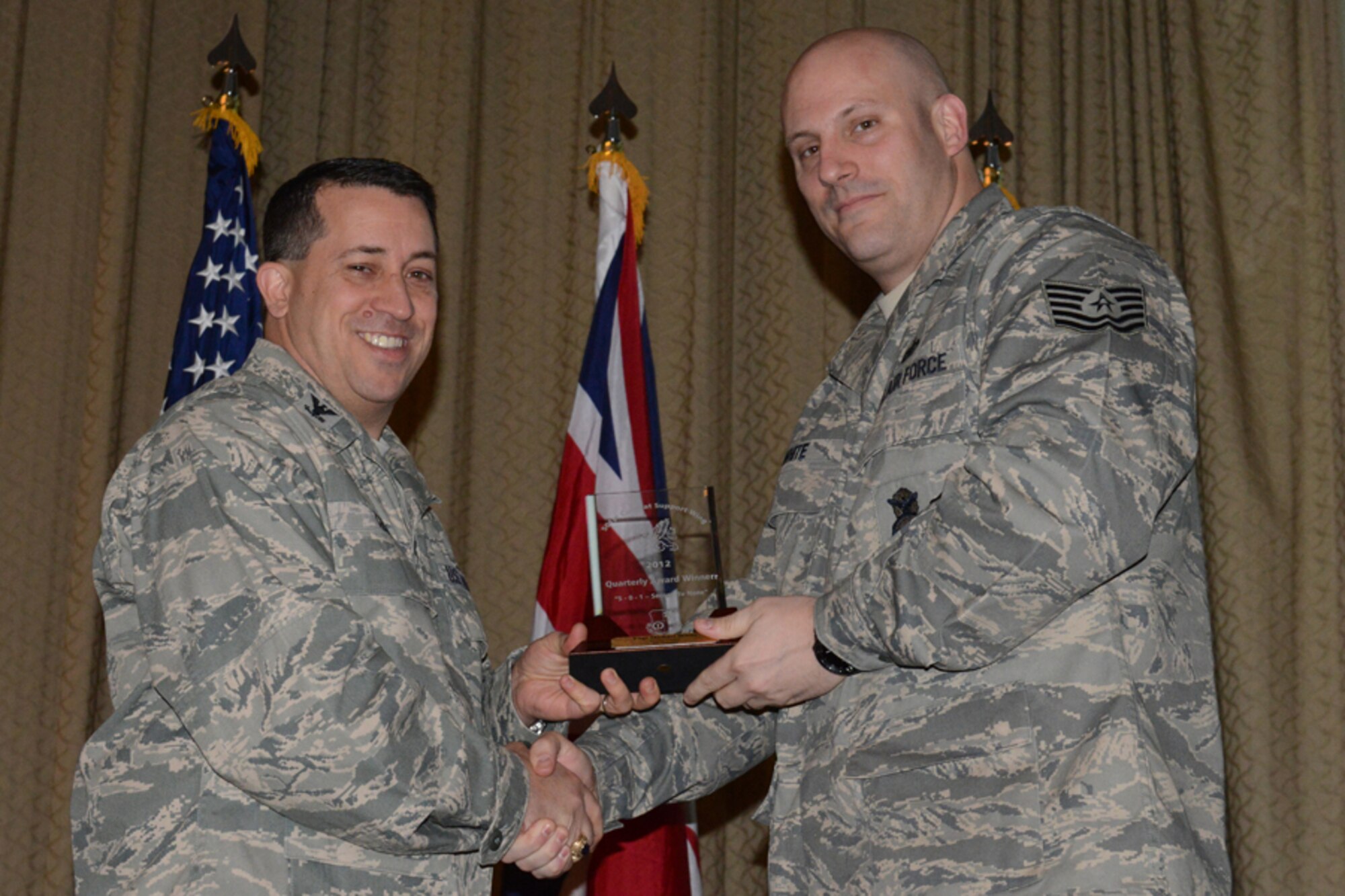 RAF ALCONBURY, United Kingdom - Col. Brian Kelly, 501st Combat Support Wing commander, presents Tech. Sgt. Michael White, 423rd Air Base Group, with an award for being named the 501st CSW Honor Guard member for the fourth quarter Jan. 16. (U.S. Air Force photo by Tech. Sgt. Chrissy Best)