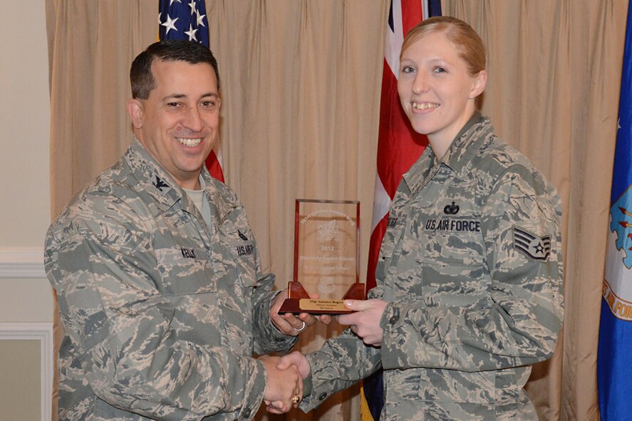 RAF ALCONBURY, United Kingdom - Col. Brian Kelly, 501st Combat Support Wing commander, presents Staff Sgt. Autumn Bogert, 501st CSW, with an award for being named the 501st CSW Military Volunteer for the fourth quarter Jan. 16. (U.S. Air Force photo by Tech. Sgt. Chrissy Best)