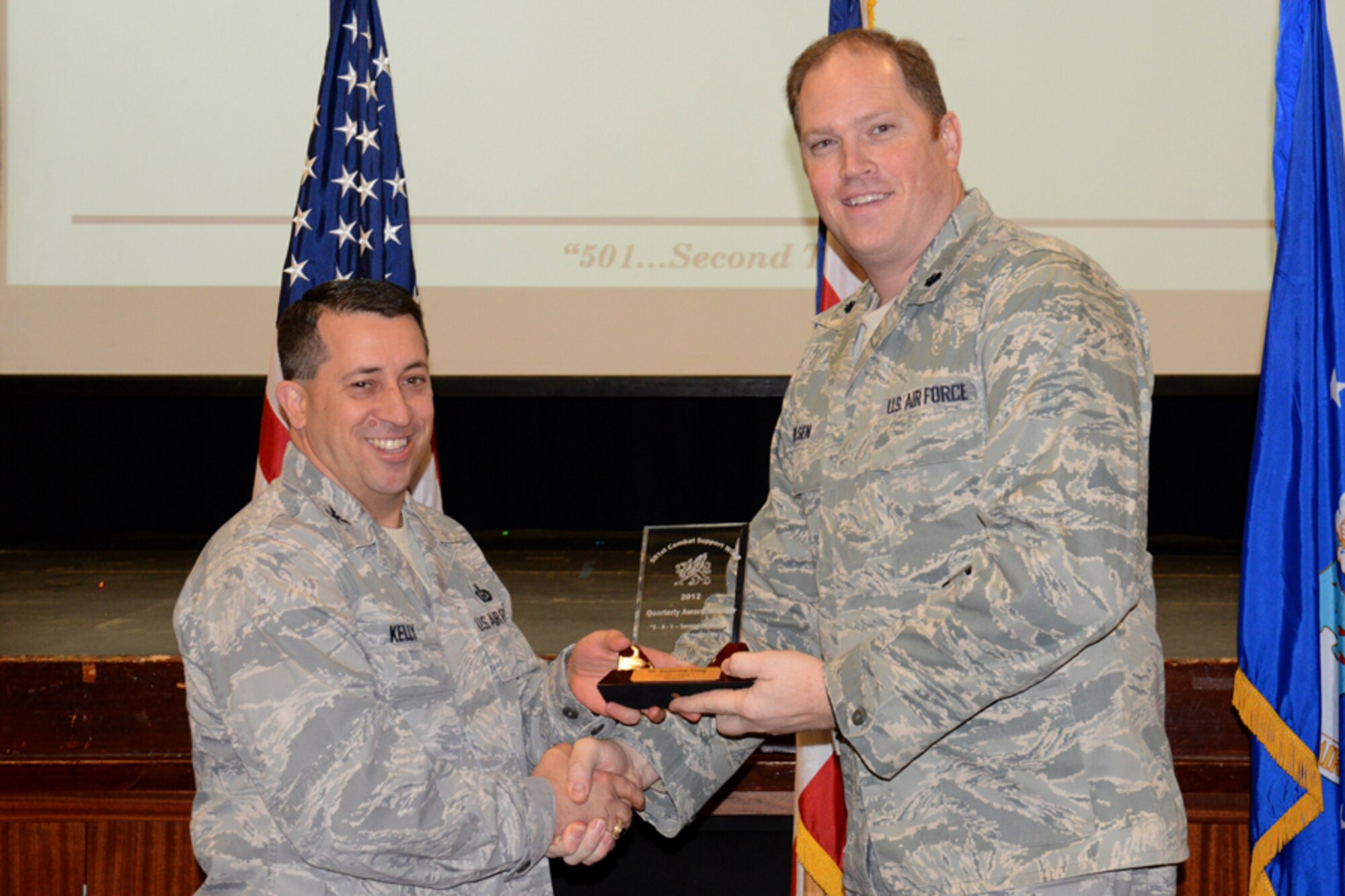 RAF CROUGHTON, United Kingdom – Lt. Col. Peter Olsen, 422nd Air Base Squadron commander, accepts the 501st CSW Civilian Category I award for the fourth quarter from Col. Brian Kelly, 501st Combat Support Wing commander, on behalf of Rasheedah Young, 422nd Air Base Group, Jan. 14. (U.S. Air Force photo by Tech. Sgt. Chrissy Best)