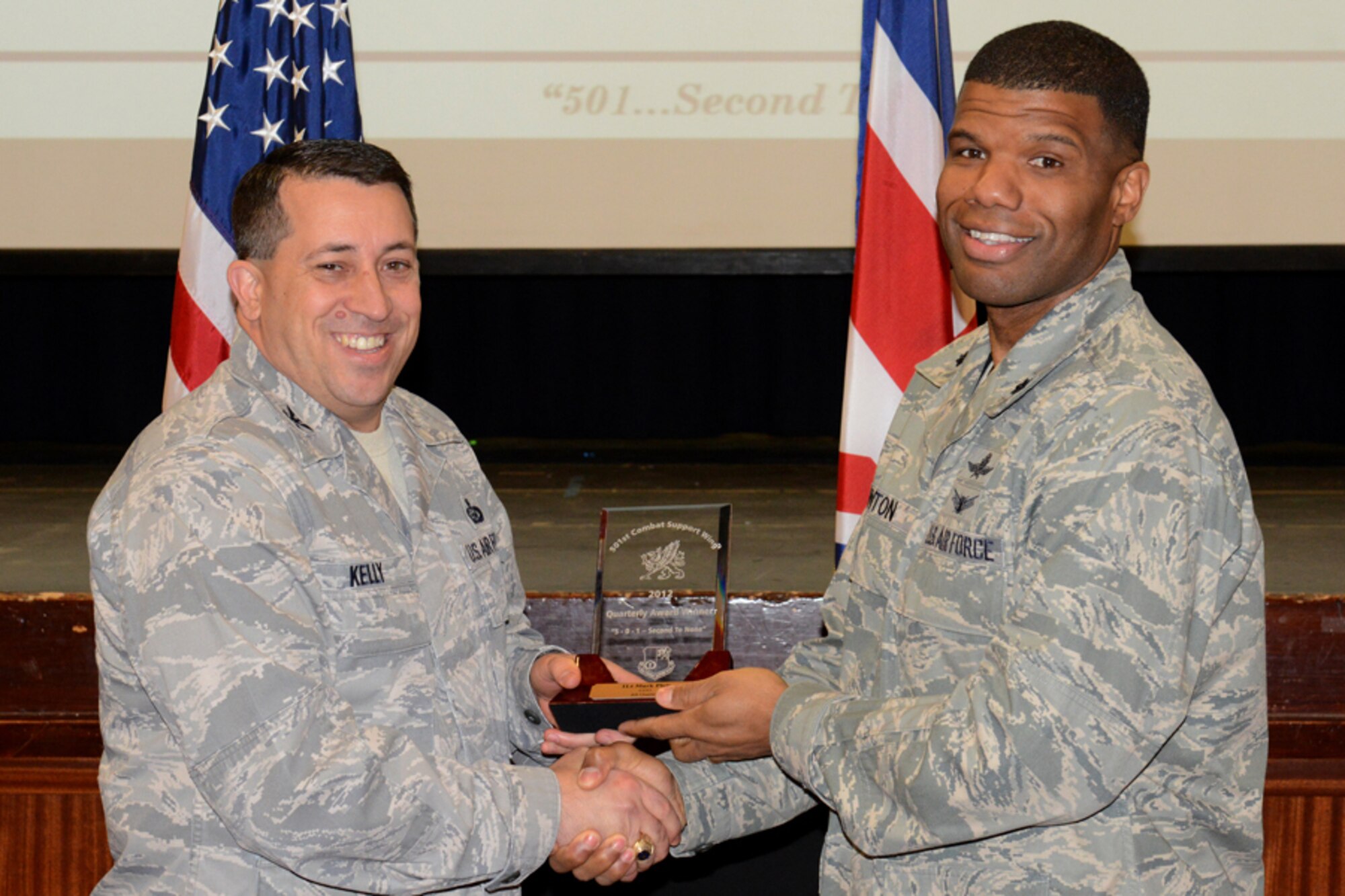 RAF CROUGHTON, United Kingdom – Lt. Col. Adisa Hinton, 422nd Communications Squadron commander, accepts the 501st CSW Company Grade Officer award for the fourth quarter from Col. Brian Kelly, 501st Combat Support Wing commander, on behalf of 1st Lt. Mark Pleis, 422nd Air Base Group, Jan. 14. (U.S. Air Force photo by Tech. Sgt. Chrissy Best)