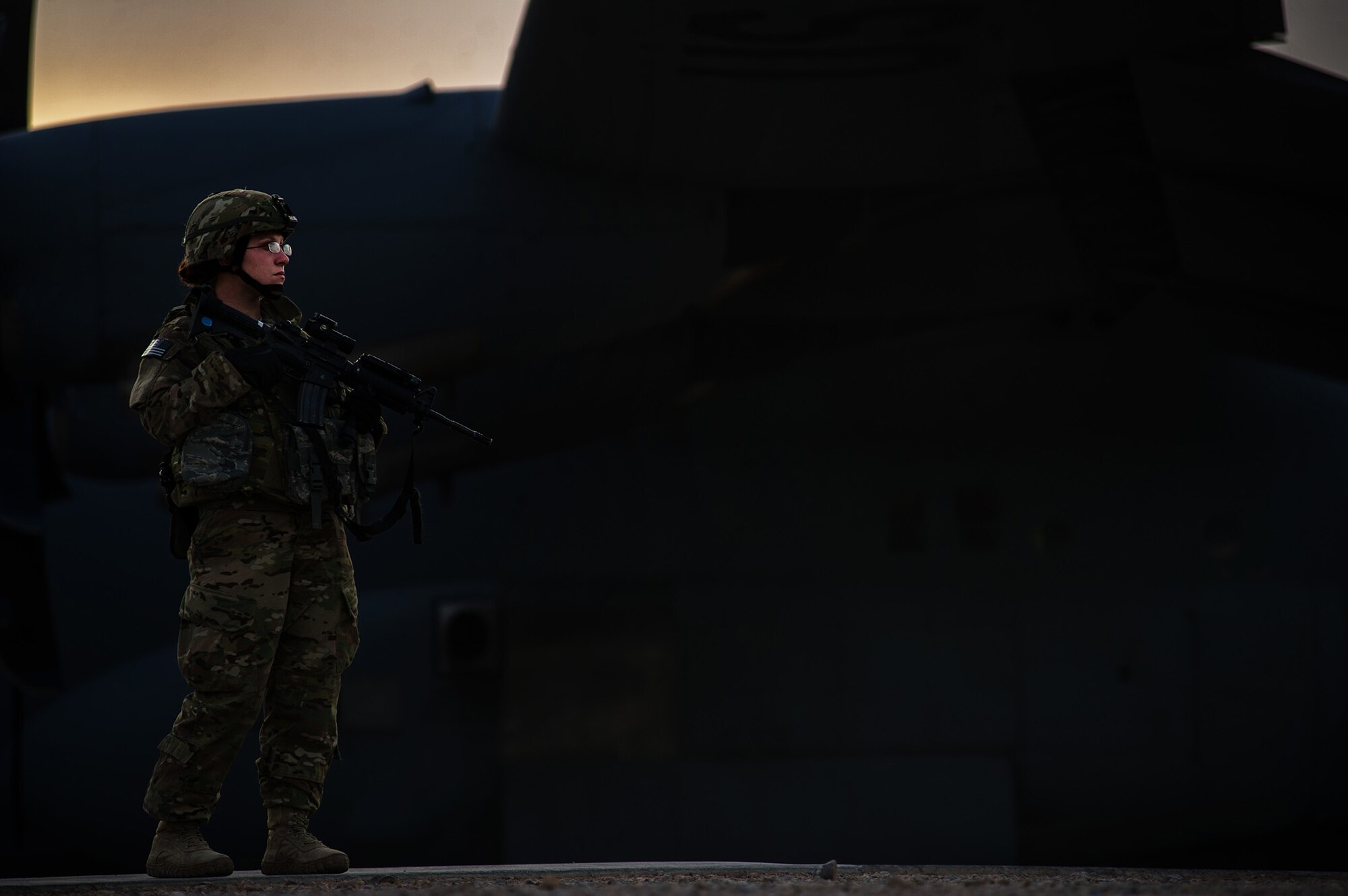 U.S. Air Force Senior Airman Bambi White, 451st Expeditionary Security Forces Squadron, provides security of a U.S. Air Force C-130J Super Hercules Dec. 5, 2012, at a forward operating base in Afghanistan. When an aircraft lands at locations with little to no security on the landing strip, fly-away security teams come along to provide additional protection for the aircraft and crew. White's hometown is Pontoon Beach, Ill. (U.S. Air Force photo/Staff Sgt. Jonathan Snyder)