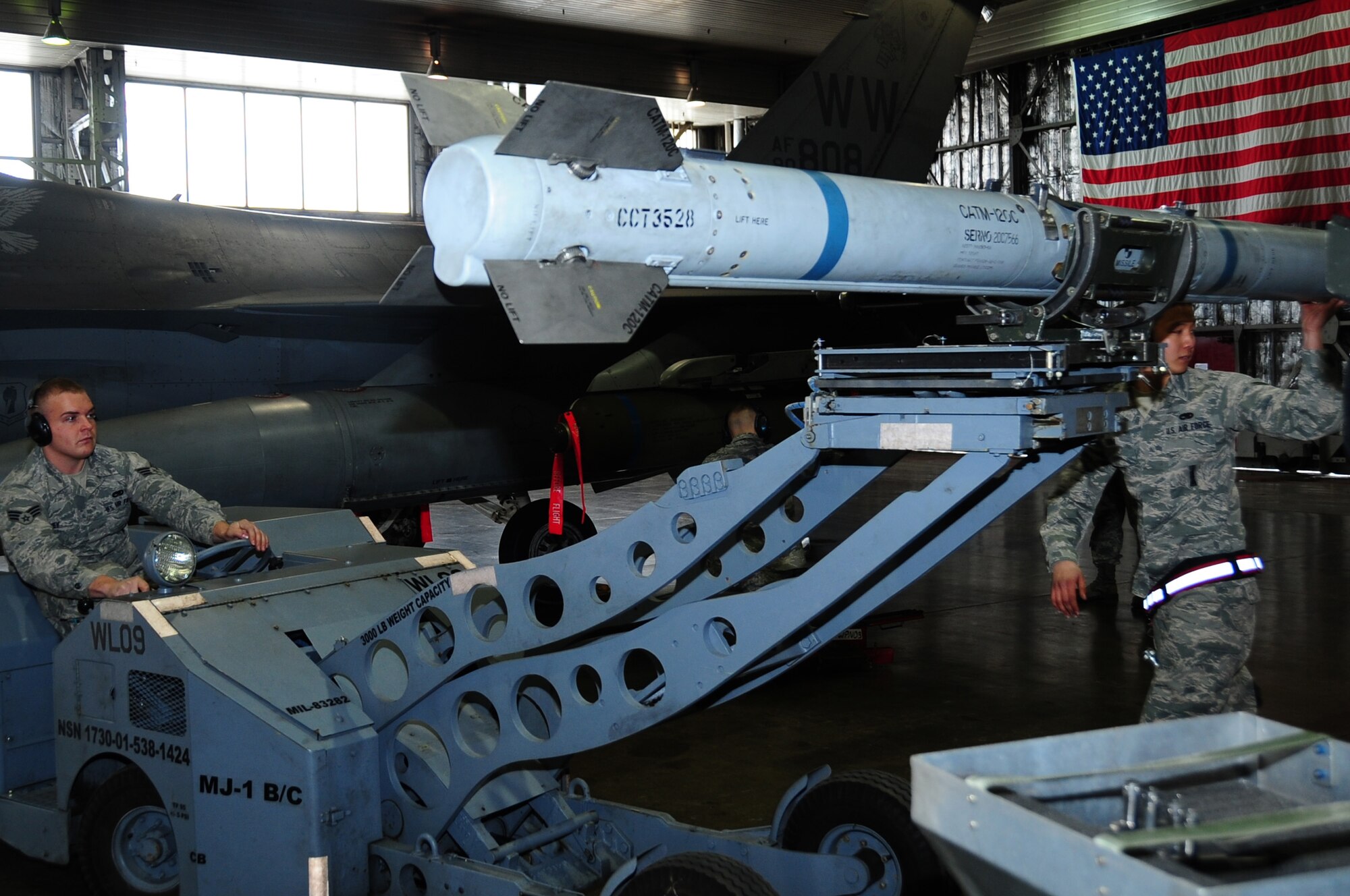 U.S. Air Force Senior Airman Ronald Olney, 13th Fighter Squadron weapons load crew member, drives a MJ-1 lift truck as Senior Airman Stephen Kim, 13 FS weapons load crew member, guides the AIM-120 Advanced Medium-Range Air-to-Air Missile during the first Load Crew of the Quarter Competition of the 2013 calendar year at Misawa Air Base, Japan, Jan. 18, 2013.  The MJ-1, known as the “jammer”, has the capacity to lift 3,000 pounds and is used to load and unload a variety of munitions.    (U.S. Air Force photo by Staff Sgt. April Quintanilla)