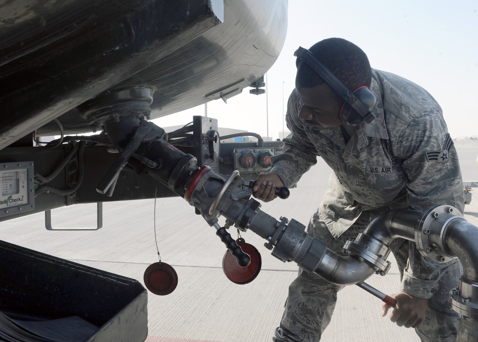 SOUTHWEST ASIA - Senior Airman Quincy Moore, 379th Expeditionary Logistics Readiness Squadron fuels distribution operator, fills his fuel truck with JP-8 from a hydrant system Jan. 22. The hydrant system allows the fuels operators to keep their vehicles on the flight line. Moore is deployed from Pope Field, N.C. (U.S. Air Force photo/Senior Airman Joel Mease)