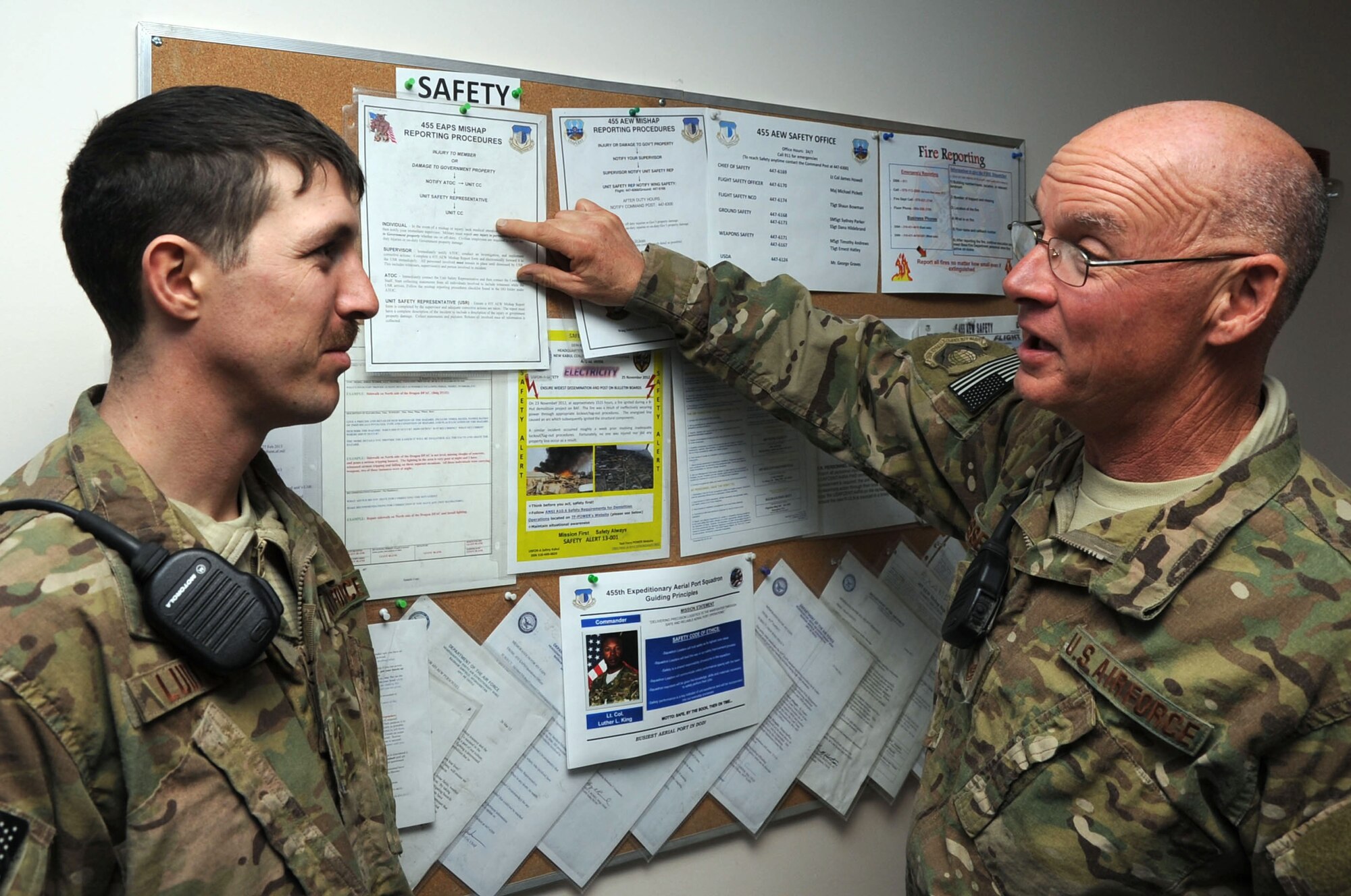 Master Sgt. Richard Messenger (right), 455th Expeditionary Aerial Port Squadron NCOIC of ramp safety, and Airman 1st Class Mark Ludlow, 455th EAPS air transportation journeyman, discuss the reporting procedures for mishaps at the Air Terminal Operations Center on Bagram Airfield, Afghanistan, Jan. 15, 2013. The 455th EAPS "Stripes on the Line" program has decreased the likelihood of mishaps and made it easier for Airmen to come forward and identify unsafe situations. (U.S. Air Force photo/Staff Sgt. David Dobrydney)