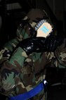 Senior Airman Kevin O’Neil, 8th Operations Support Squadron, uses a brush and bleach water to decontaminate his mask during exercise Beverly Midnight 13-1 at Kunsan Air Base, Republic of Korea, Jan. 18, 2013. O’Neil became contaminated after a sweep around his facility. (U.S. Air Force photo by Senior Airman Marcus Morris/Released)  