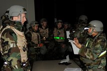 Tech. Sgt. Dequita Taylor, right, and Staff Sgt. Jeremy Smith, from the 8th Force Support Squadron, assign inbound Airmen a dorm room during exercise Beverly Midnight 13-1 at Kunsan Air Base, Republic of Korea, Jan. 18, 2013. The simulation allowed the members of the 8th Fighter Wing to practice defending the base, accepting follow on forces and taking the fight north. (U.S. Air Force photo by Senior Airman Marcus Morris/Released)