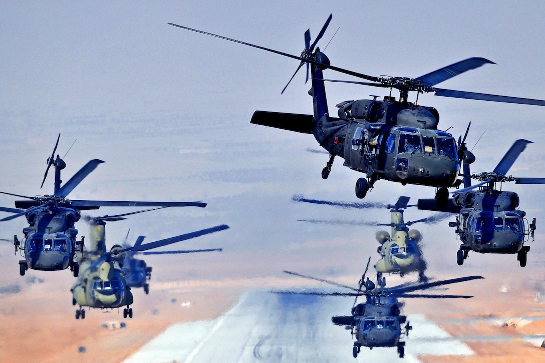A formation of six UH-60L Black Hawks and two CH-47F Chinooks helicopters simultaneously launch a daytime mission from Multinational Base Tarin Kowt, Afghanistan, Jan. 18, 2013. The helicopter crews are assigned to the 4th Battalion, 3rd Aviation Regiment, Task Force Falcon.