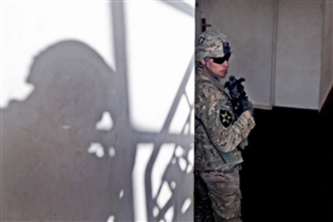 U.S. Army Spc. Joseph Gonzalez provides security during a meeting with the provincial Directorate of Agriculture, Irrigation and Livestock in Farah City, Afghanistan, Jan. 22, 2013. Gonzalez is assigned to Provincial Reconstruction Team Farah.