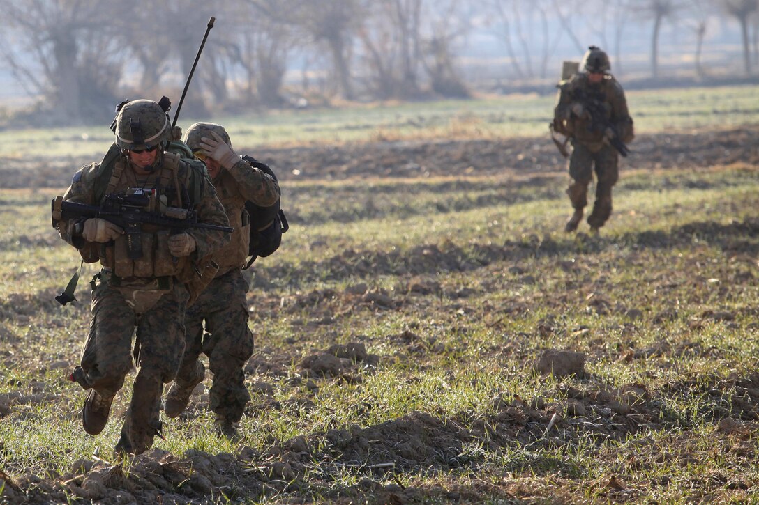 Marine advisors attached with the Afghan National Army run to a compound to take cover while receiving enemy fire during Operation New Hope, Kajaki, Afghanistan, Jan. 16. During the three-day operation, more than 100 ANA soldiers along with various Afghan National Security Forces elements cleared weapons caches, improvised explosive devices and enemy fighting positions from the area. Accompanying the ANA were 18 Marine advisors providing call for fires and tactical input when needed.