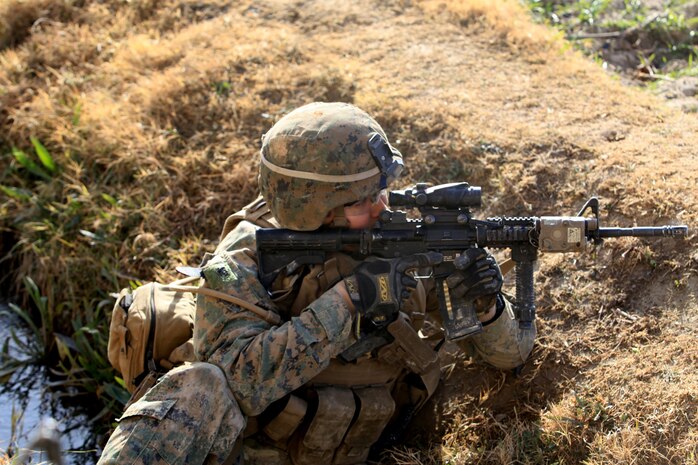 Petty Officer 2nd Class Jovan Delafuente, a corpsman with the Security Force Assistance Advisor Team, Regimental Combat Team 7, provides security while halted behind a compound during Operation New Hope, Kajaki, Afghanistan, Jan. 16. During the three-day operation, more than 100 ANA soldiers along with various Afghan National Security Forces elements cleared weapons caches, improvised explosive devices and enemy fighting positions from the area. Accompanying the ANA were 18 Marine advisors providing call for fires and tactical impute when needed.