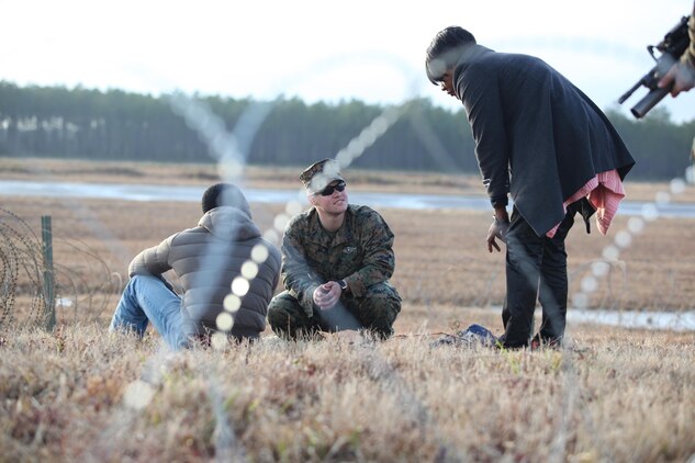 Petty Officer 3rd Class Andrew Sanders, a hospital corpsman with Black Sea Rotational Force 13, and an Elizabeth City, N.C., native, uses an interpreter to check the medical health of a detainee. Marines and sailors with the 2013 iteration of BSRF conducted their first noncombatant evacuation mission rehearsal exercise the week of January 7. 