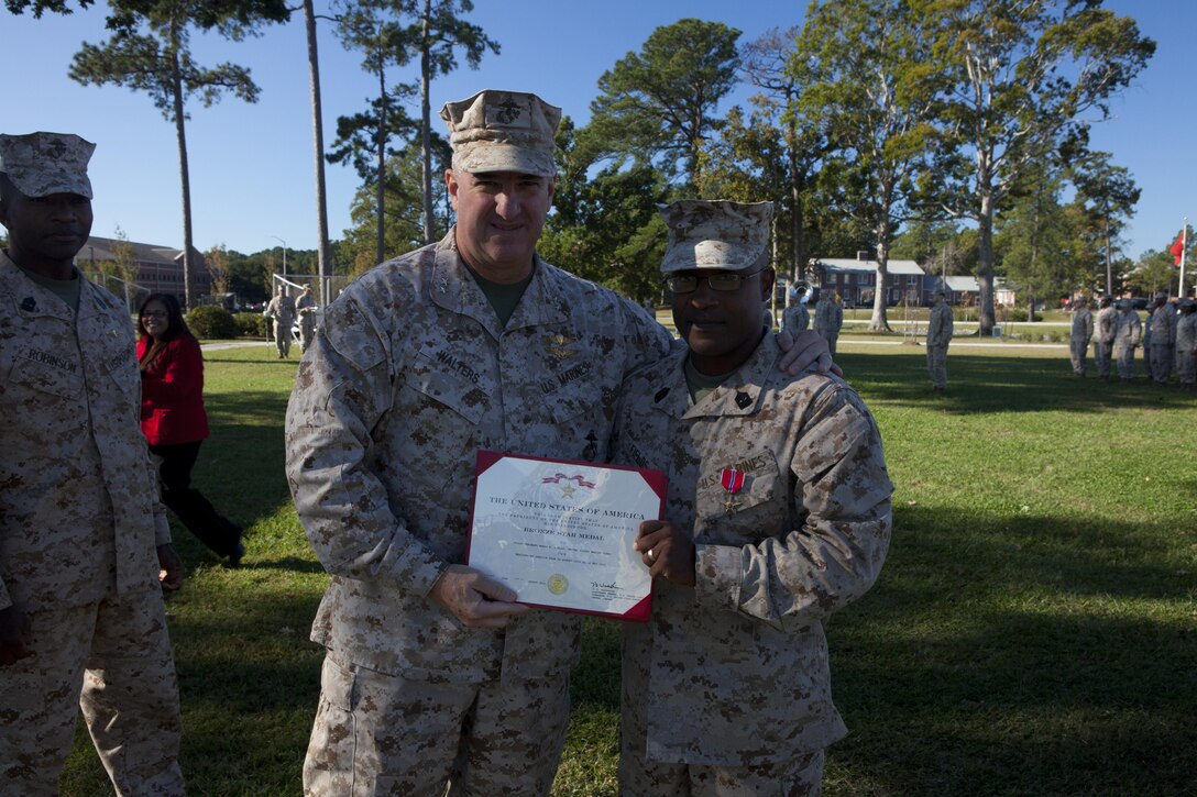 Maj. Gen. Glenn M. Walters, commanding general of 2nd Marine Aircraft Wing, presents Sgt. Maj. Mario P. Fields, Marine Wing Headquarters Squadron 2, with a Bronze Star during a ceremony on Cherry Point Nov. 1. 