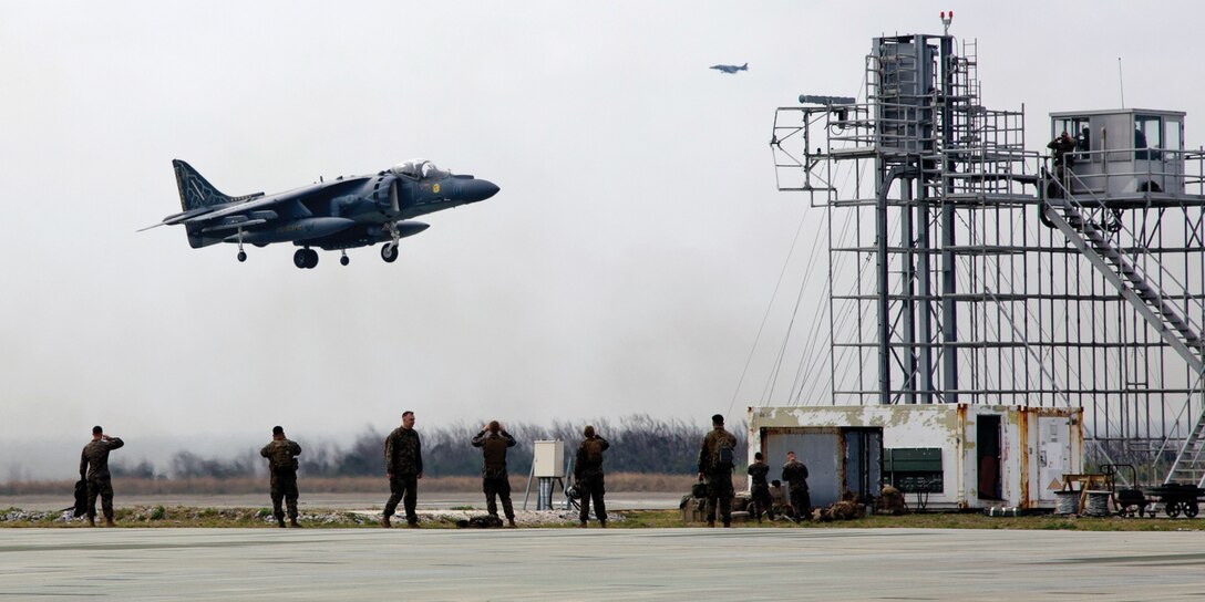 An AV-8B Harrier prepares to land on the field carrier landing strip at Ie Shima training facility during bulk refueling training Jan. 16. Marine Wing Support Squadron 172 prepared the landing strip to allow aircraft with Marine Attack Squadron 513 to conduct field carrier landing practice while MWSS-172 refueled the harriers. VMA-513 currently has aircraft attached to Marine Medium Helicopter Squadron 262, which is the aviation combat element of the 31st Marine Expeditionary Unit. MWSS-172 is a part of Marine Aircraft Group 36, 1st Marine Aircraft Wing, III Marine Expeditionary Force.