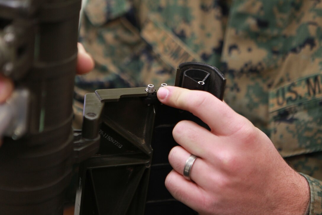 Sgt. Jeremy Simms, LAAD class advisor, Co. C, MCCES, explains the importance of the torque screws on a field handling training version of the FIM-92 Stinger.