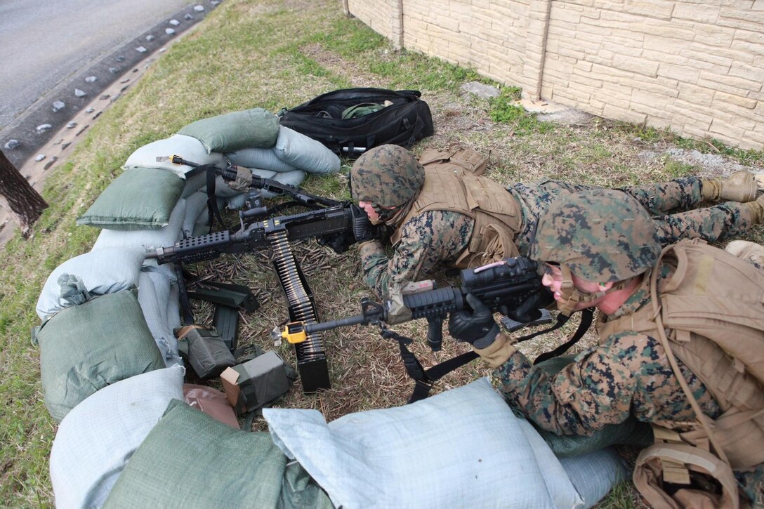 Marines provide suppressive fire during a mock attack Jan. 16 at combat town in the Central Training Area near Camp Hansen during military operations in urban terrain training. The Marines learned how to properly negotiate obstacles such as stairwells that could otherwise place them in a tactical disadvantage while operating in close quarters in urban terrain. The Marines are with Combat Assault Battalion, 3rd Marine Division, III Marine Expeditionary Force.