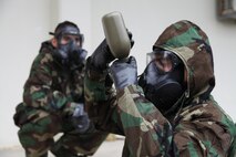 Cpl. Devon A. Luevano demonstrates the proper way to hydrate while wearing mission oriented protective posture gear during a communications exercise Jan. 16 at Camp Foster. During the exercise, the Marines wore MOPP gear while performing their day-to-day tasks, ranging from radio checks to communications site setup. Luevano is a field wireman with Combat Logistics Battalion 4, Combat Logistics Regiment 3, 3rd Marine Logistics Group, III Marine Expeditionary Force.
