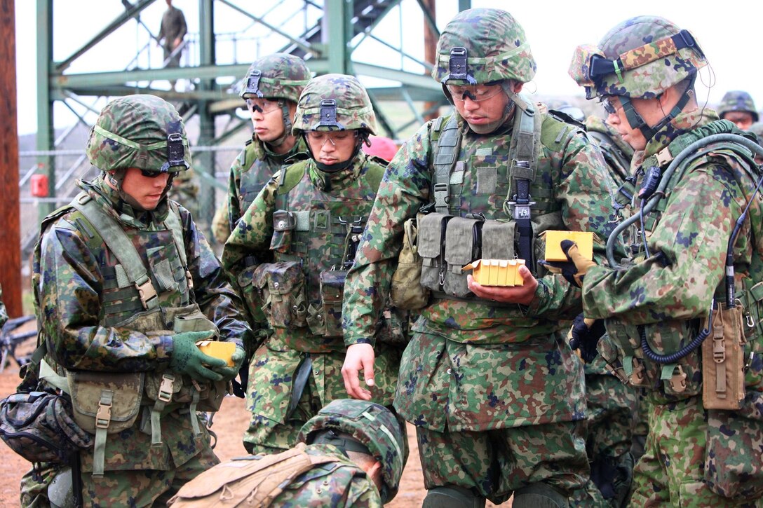 Members of the Japan Ground Self-Defense Force collect ammo to be used during maneuver under fire training as part of Exercise Iron Fist 2013, aboard Marine Corps Base Camp Pendleton, Calif. Jan. 24, 2013. During Iron Fist 2013, the 13th Marine Expeditionary Unit and Western Army Infantry Regiment, JGSDF will spend three weeks participating in bilateral training to improve their interoperability, enhance military-to-military relations and sharpen skills essential to crisis response.  (U.S. Marine Corps photo by Cpl. Jennifer J. Pirante/Released)