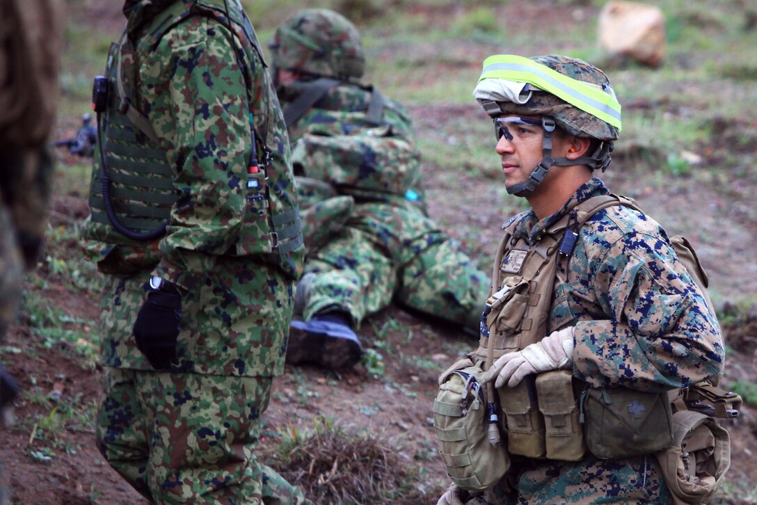 A U.S. Marine rifleman with 1st Battalion, 4th Marine Regiment, 1st Marine Division, observes members of the Japan Ground Self-Defense Force during maneuver under fire training as part of Exercise Iron Fist 2013, aboard Marine Corps Base Camp Pendleton, Calif. Jan. 24, 2013. During Iron Fist 2013, the 13th Marine Expeditionary Unit and Western Army Infantry Regiment, JGSDF will spend three weeks participating in bilateral training to improve their interoperability, enhance military-to-military relations and sharpen skills essential to crisis response.  (U.S. Marine Corps photo by Cpl. Jennifer J. Pirante/Released)