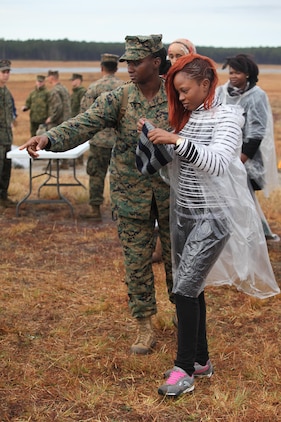 Staff Sgt. Jacquelyn Gibson, a delivery chief with the Black Sea Rotational Force 13, shows a role player where the administration tent is so she can proceed to the next stage. Marines and sailors with the 2013 iteration of BSRF conducted their first noncombatant evacuation mission rehearsal exercise the week of January 7.