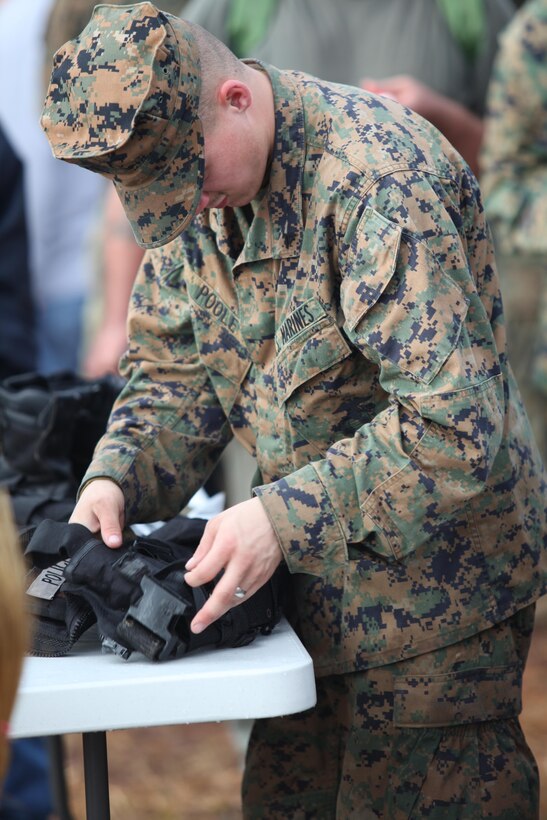 Lance Cpl. Joshua Poole, a motor transport mechanic with the Black Sea Rotational Force 13, searches a bag for contraband during the screening station of the mock Evacuation Control Center. Marines and sailors with the 2013 iteration of BSRF-13 conducted their first noncombatant evacuation mission rehearsal exercise the week of January 7. 