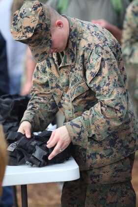 Lance Cpl. Joshua Poole, a motor transport mechanic with the Black Sea Rotational Force 13, searches a bag for contraband during the screening station of the mock Evacuation Control Center. Marines and sailors with the 2013 iteration of BSRF-13 conducted their first noncombatant evacuation mission rehearsal exercise the week of January 7. 