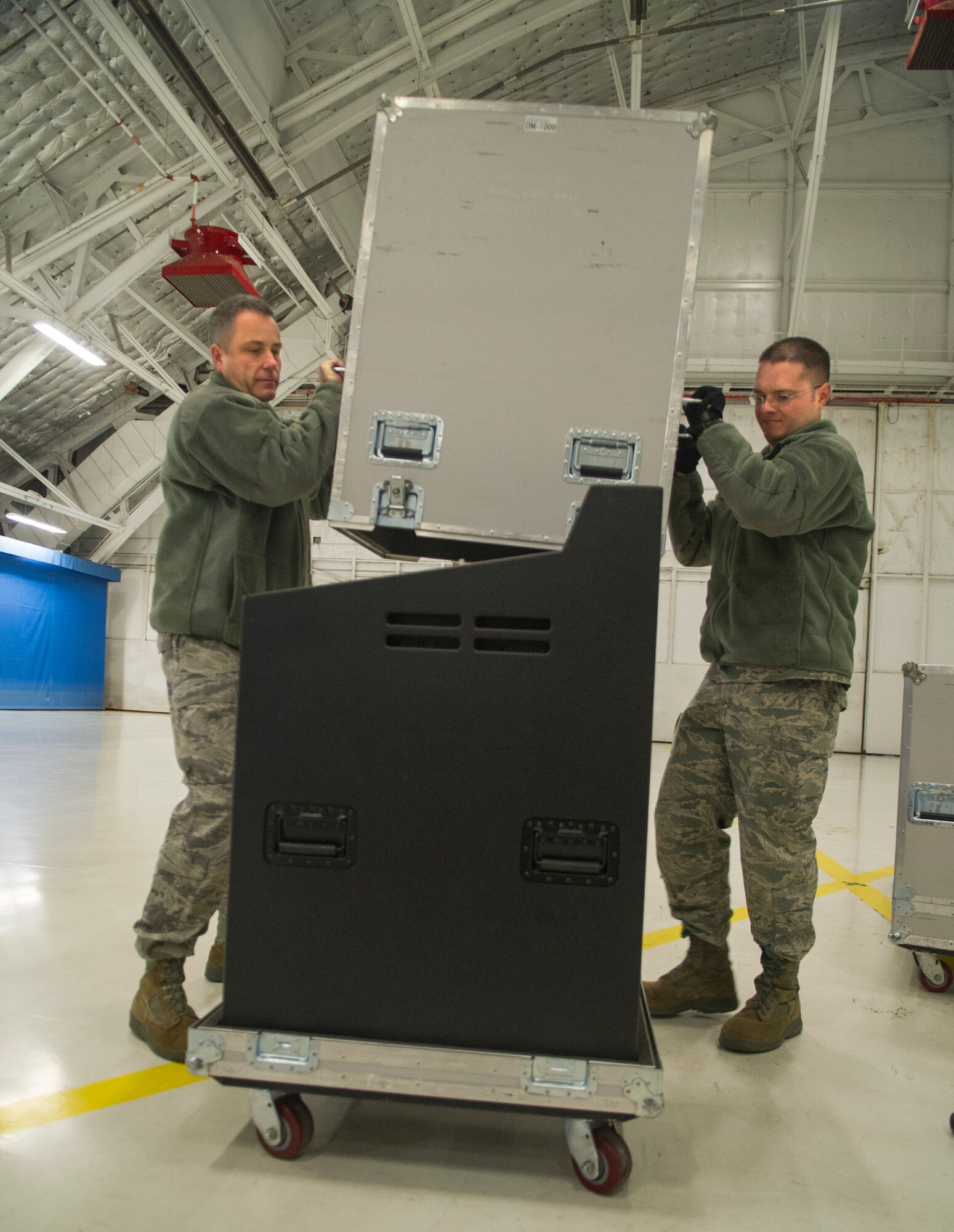 U.S. Air Force Band audio engineers, Master Sgt. Adam Dempsey (right) and Master Sgt. David Graves pack up communication equipment following the Air Force Ceremonial Element rehearsal for the 57th Presidential Inaugural parade on Joint Base Andrews, Md., Jan. 11, 2013. Graves and Dempsey make up the six-man team of audio engineers who support the band. Dempsey is a native of Dexter, Mich., and Graves hails from Eugene, Ore. (U.S. Air Force photo by 1st Lt. Ashleigh Peck)