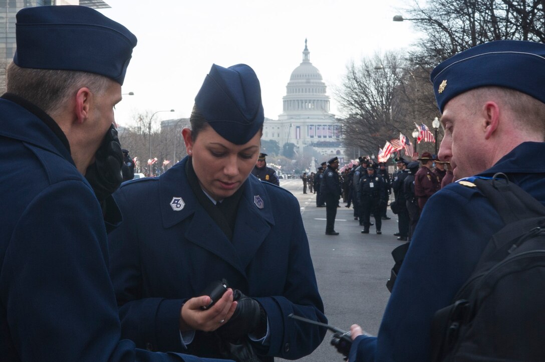 Air Force cordon members test their radios as they prepare for the 57th Presidential Inaugural Parade Jan. 21, 2013 in Washington.  Providing an Air Force cordon was one of the many ways the Air Force supported the inaugural events. Other support came from Air Force Bands and Choruses, Honor Guards, Marching Units, Reserve and Guard, as well as myriad contingency, communication, and command and control operations taking place behind the scenes. (U.S. Air Force Photo by 1st Lt. Ashleigh Peck)