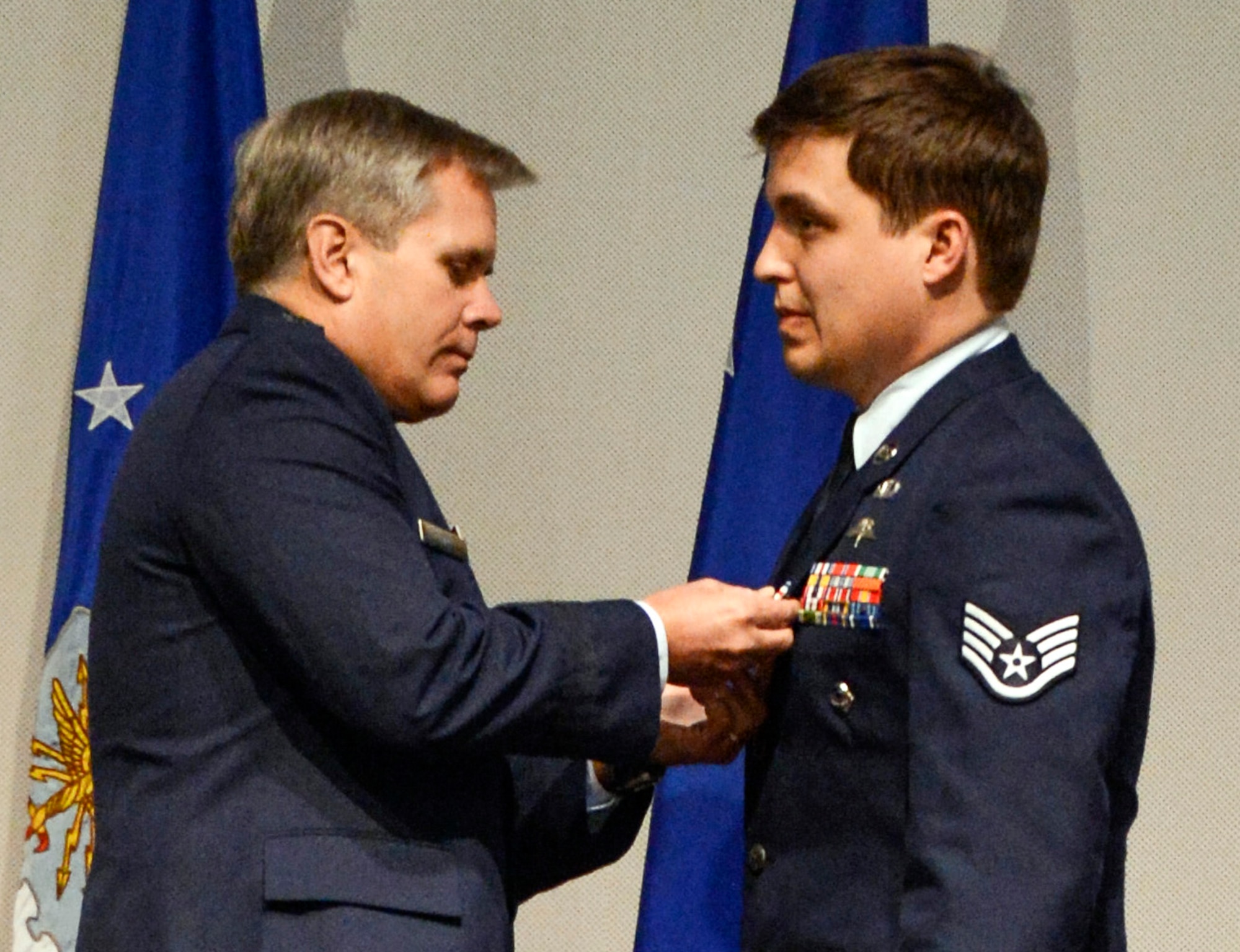 Lt. Gen. Eric E. Fiel, Air Force Special Operations Command commander, pins the Silver Star Medal onto Staff Sgt. Adam Krueger, 22nd Special Tactics Squadron combat controller, Jan. 24, 2013, at a ceremony at Joint Base Lewis-McChord, Wash. Krueger was awarded the medal for displaying gallantry in action against an armed enemy of the United States, risking his life in order to direct life-saving air support, as well as exposing himself in order to direct a medical evacuation helicopter to the scene, during a 12-hour firefight in Afghanistan in 2010. (U.S. Air Force photo/Staff Sgt. Sean Tobin)